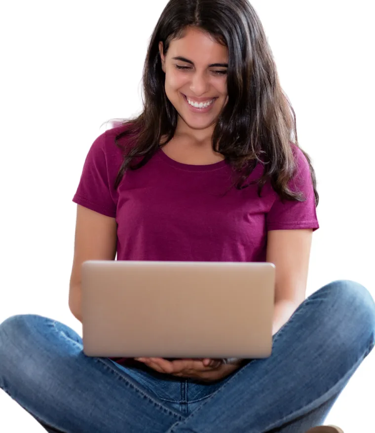A founder smiling while building her store on a laptop